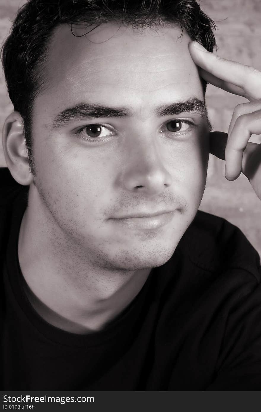 Male model against a rough brick wall background