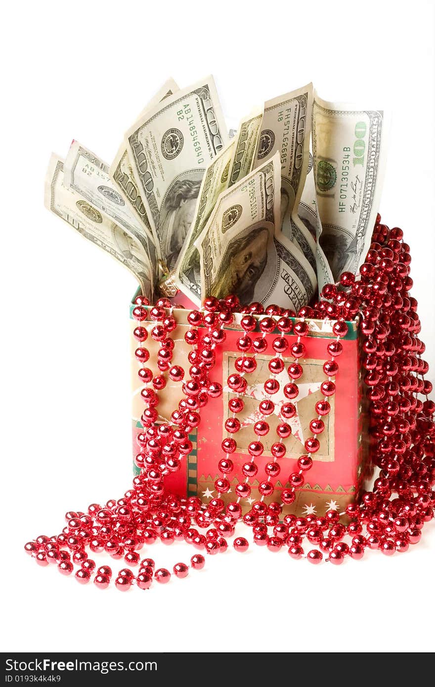 Money in a red gift box on a white background