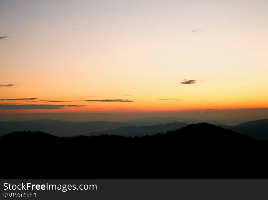 An image of a sunset in mountains