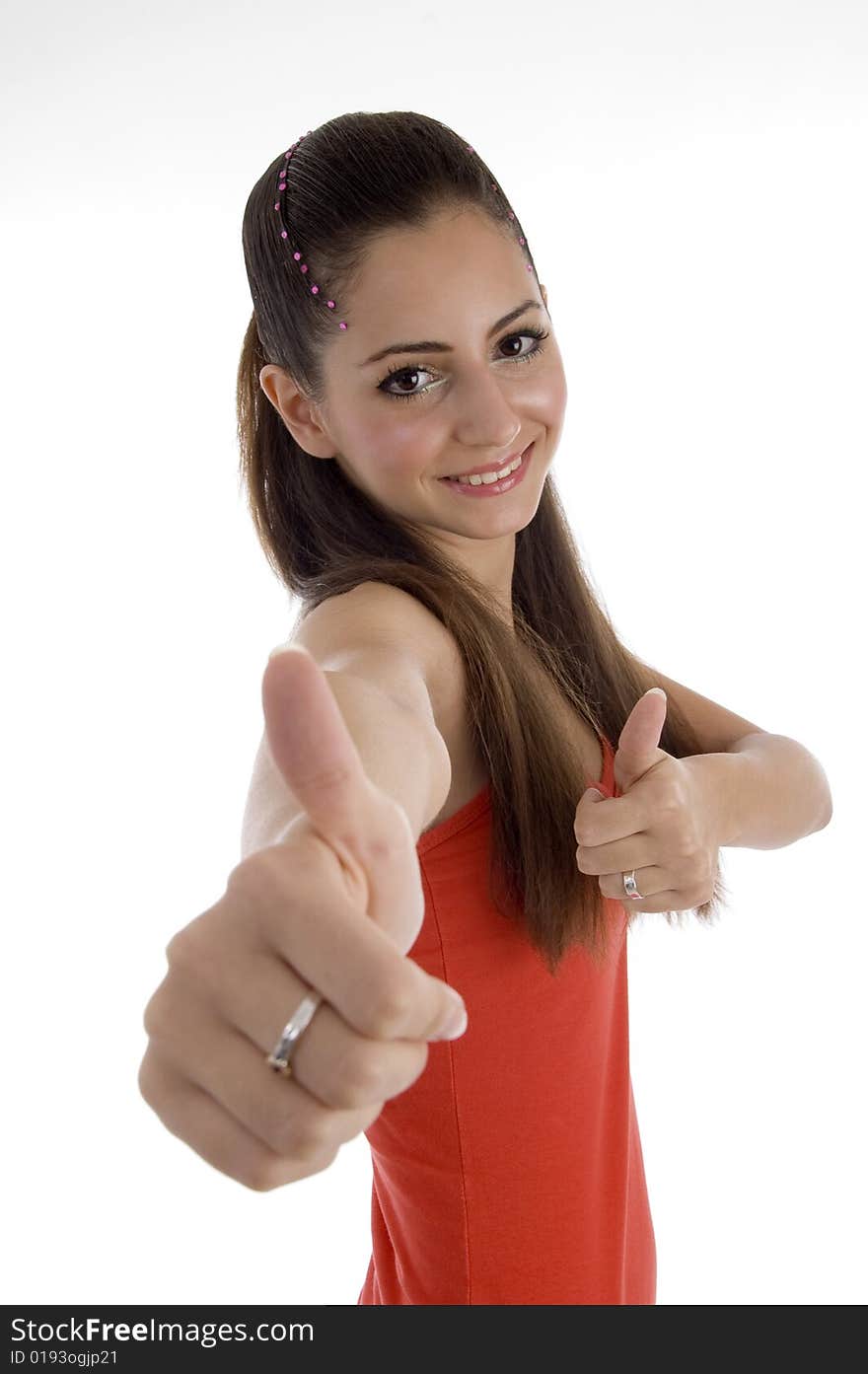 Smiling girl with beautiful hairstyle showing thumb gesture against white background