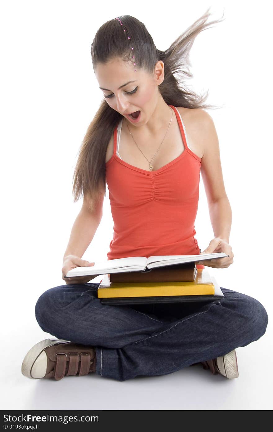 Surprised student looking into book on an isolated background