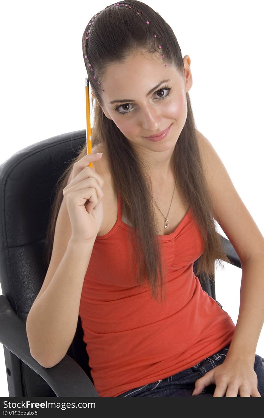 Teenager girl holding pencil and looking at camera on an isolated white background