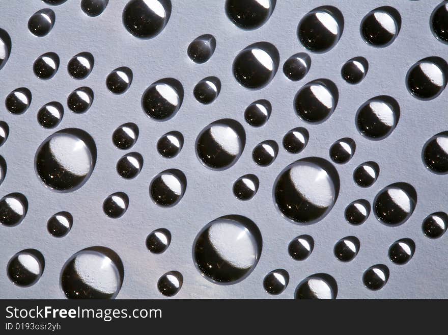 Abstract background with water drops on grey glass