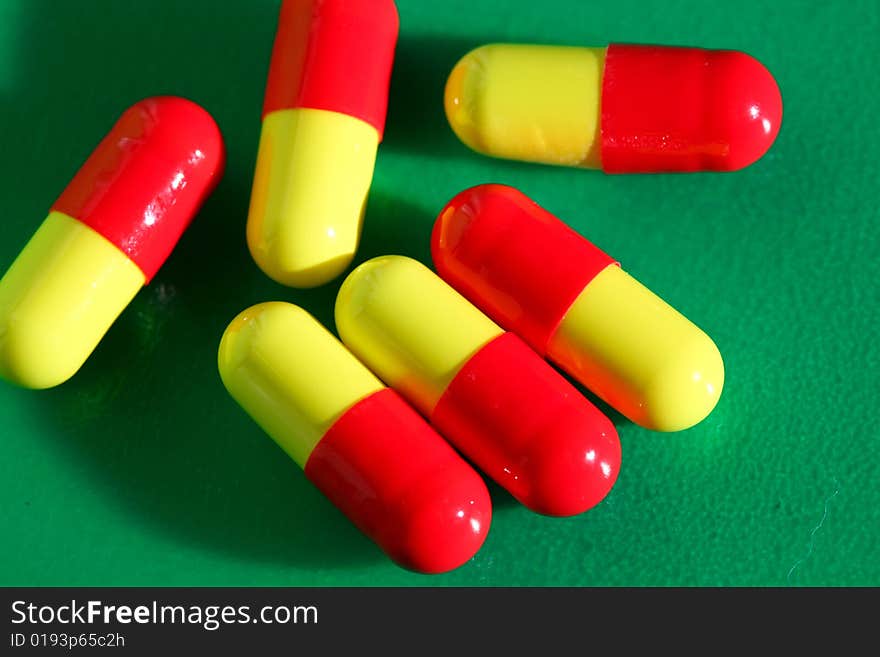 An image of pills on green background