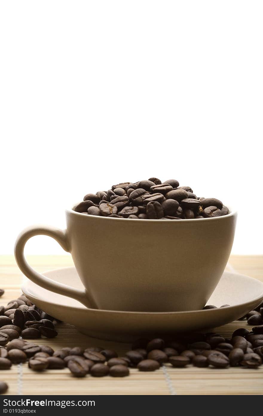 Cup of coffee and coffee beans isolated on white