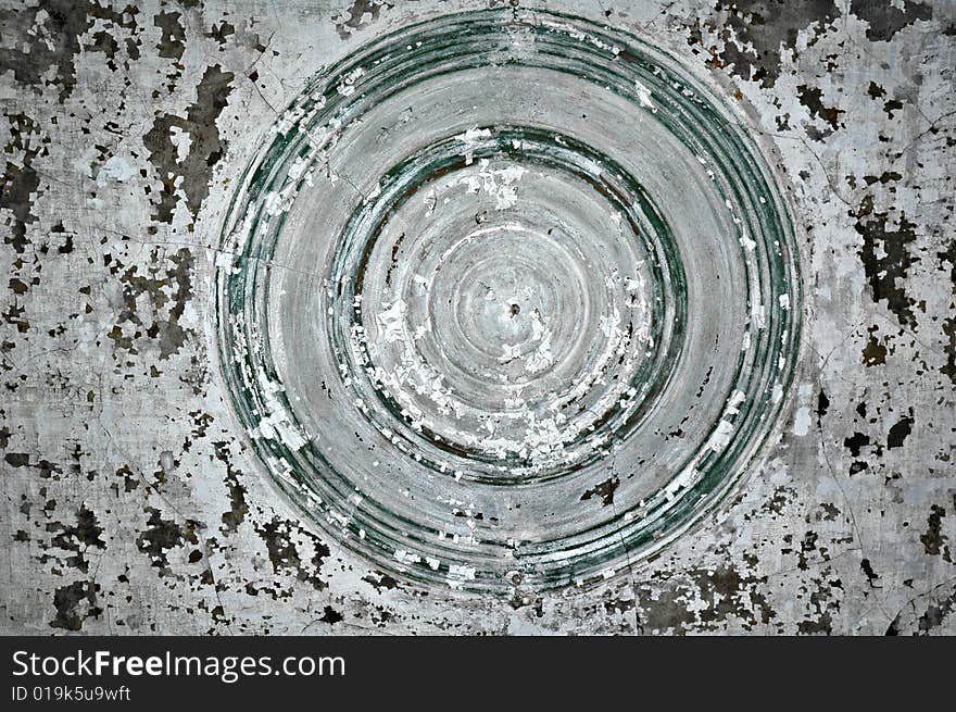 A view of the cracked and peeling paint of a ceiling in an old building with circles.  Suitable for abstract background. A view of the cracked and peeling paint of a ceiling in an old building with circles.  Suitable for abstract background.