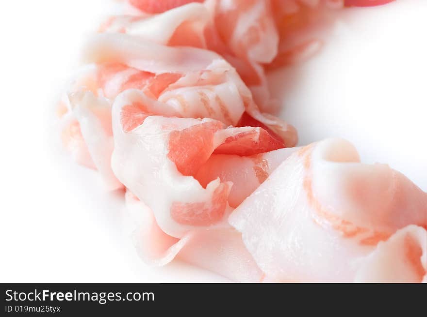 Slices of prosciutto, italian ham on white background