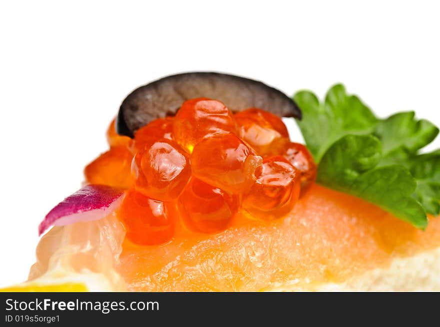 Macro shot of canape with red caviar, cmoked salmon and vegetables