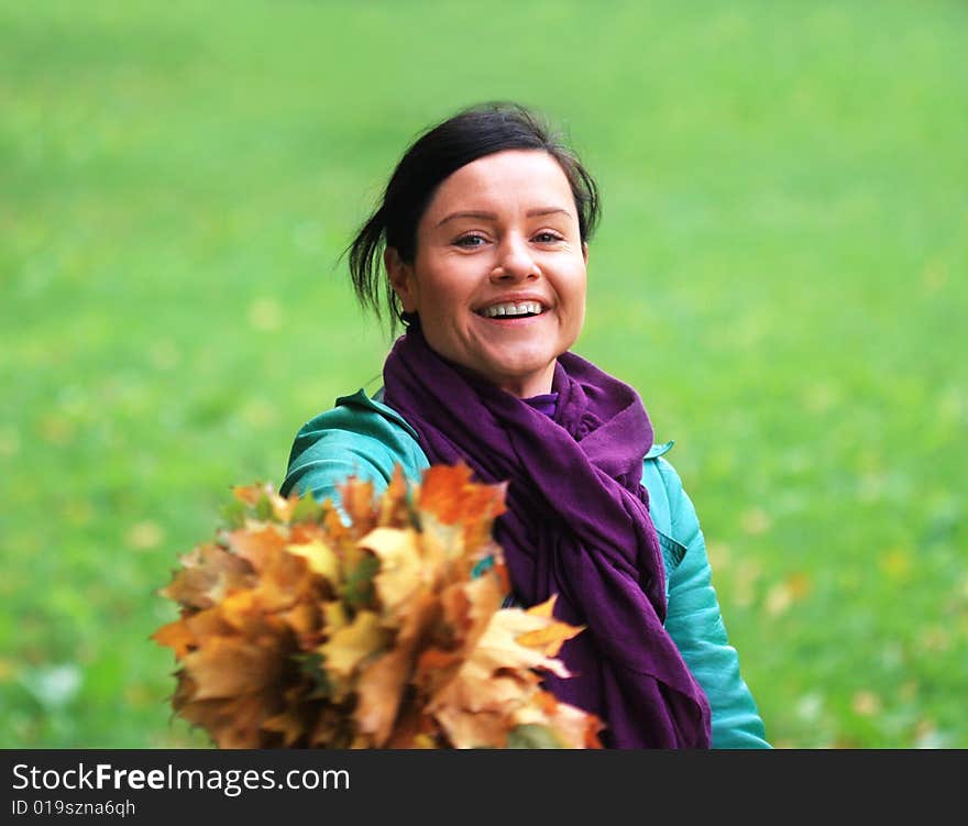 Smile woman joys fallen leaves. Smile woman joys fallen leaves