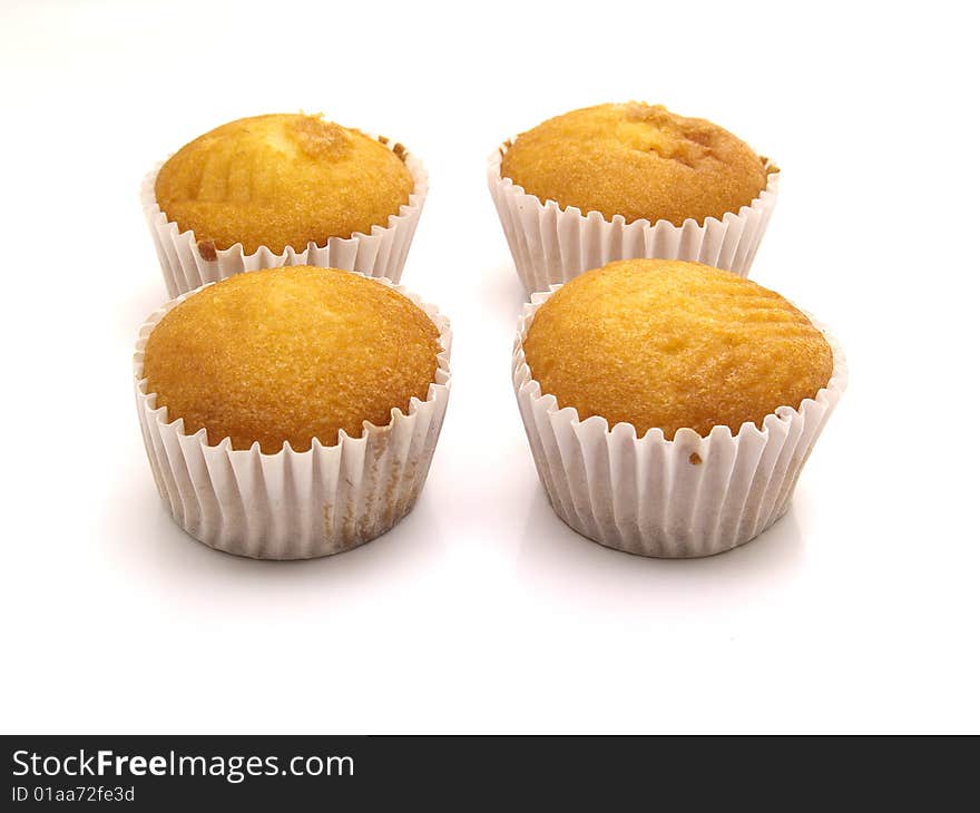 Magdalenas, sponge cakes 	
isolated on a white background