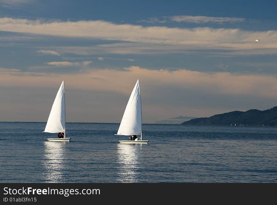 Two sailing boats in the sea. Two sailing boats in the sea.