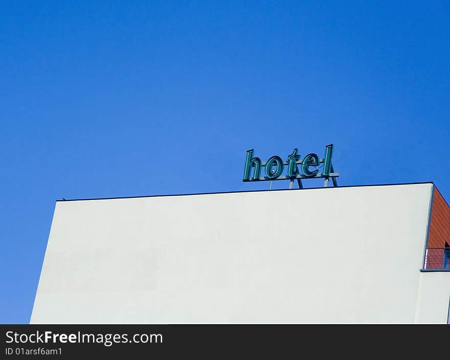 Hotel white building wall against blue clear sky. Hotel white building wall against blue clear sky