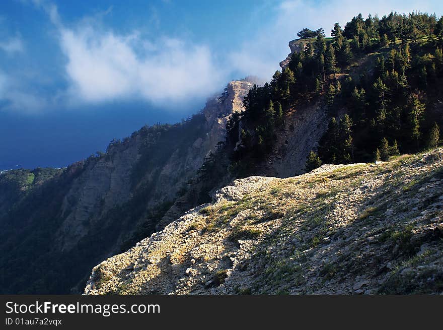 The sun makes bright a part of mountain landscape. The sun makes bright a part of mountain landscape