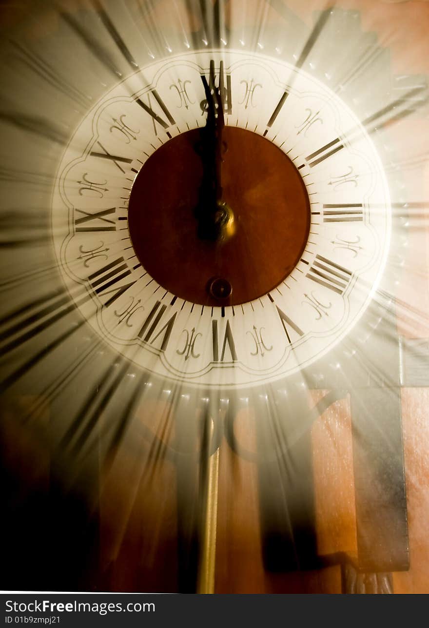Old vintage clock showing 12 o'clock blurred in
