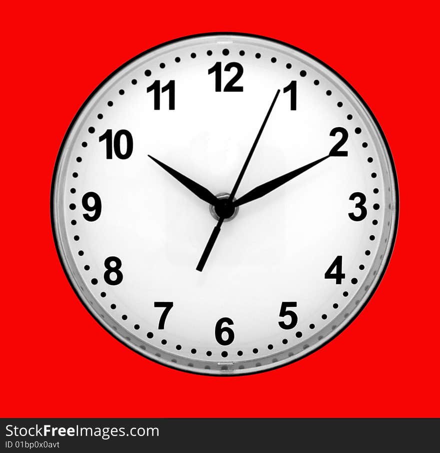 Dial of clocks with arrows on a red background.