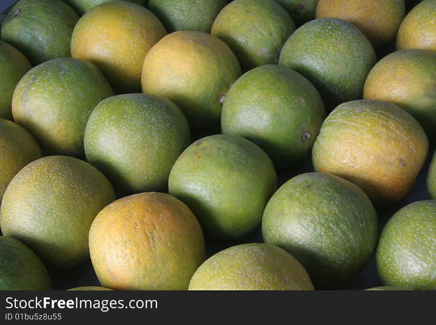 Neatly stalked sweet lemon fruits in a stall