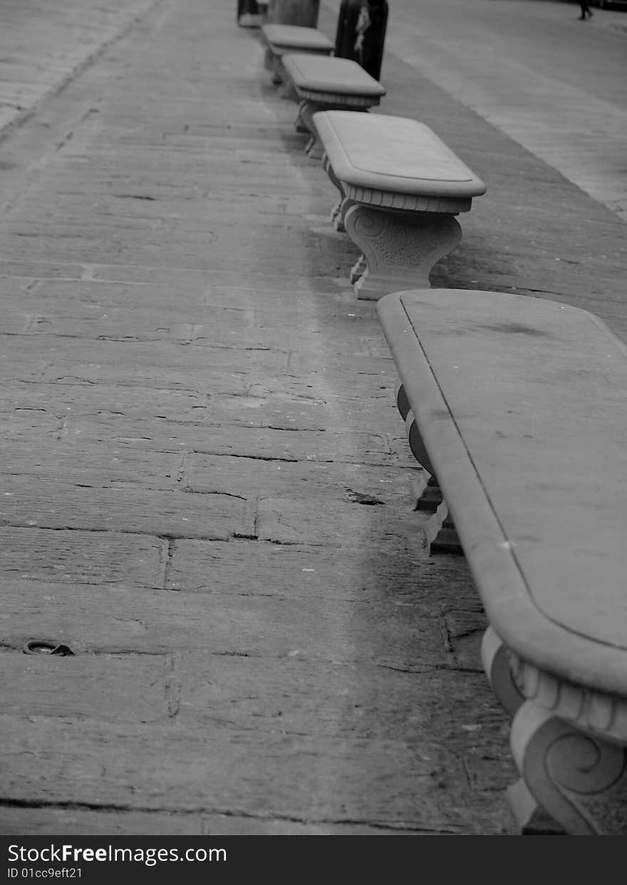 A suggestive monochrome of a row of benches in Florence. A suggestive monochrome of a row of benches in Florence