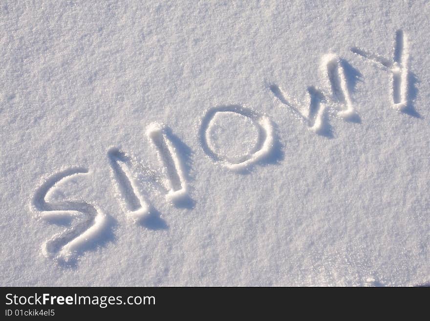 Writing text SNOWY in sunny day on the snow