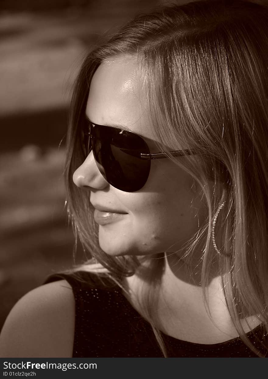 Young Woman With Sun Glasses In Sepia