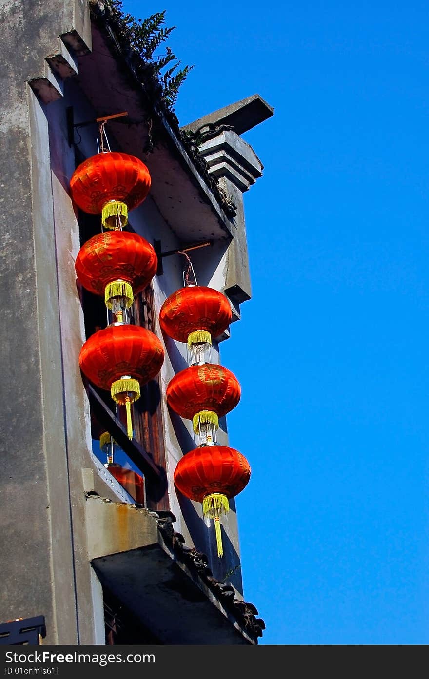 Some red lantern hang out  on the house. Some red lantern hang out  on the house