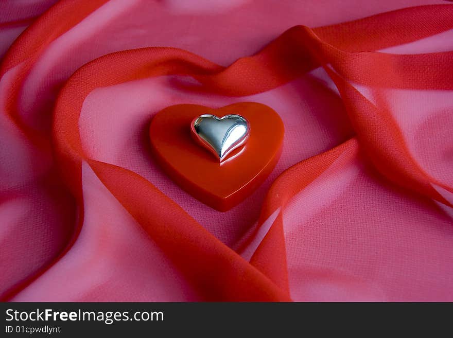 Shiny heart on a small box as a heart on a red background. Shiny heart on a small box as a heart on a red background