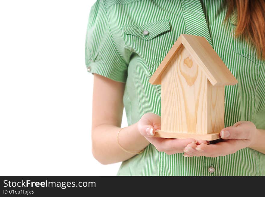 Little home in the hands of young woman, on the white background