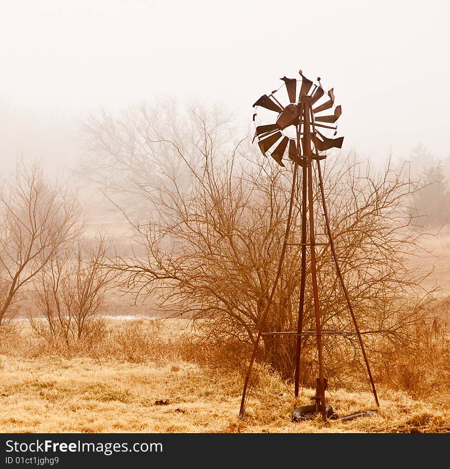 Old windmill shrouded by fog. Old windmill shrouded by fog