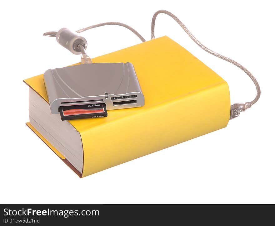 Yellow hardback books with a compact flash card reader isolated on a white background