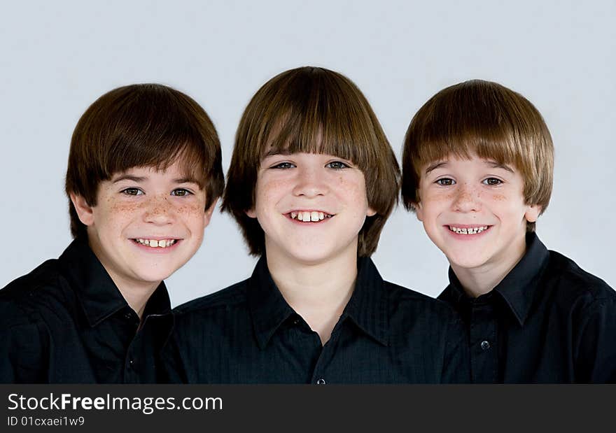 Three Cute Smiling Brothers Dressed in Black. Three Cute Smiling Brothers Dressed in Black