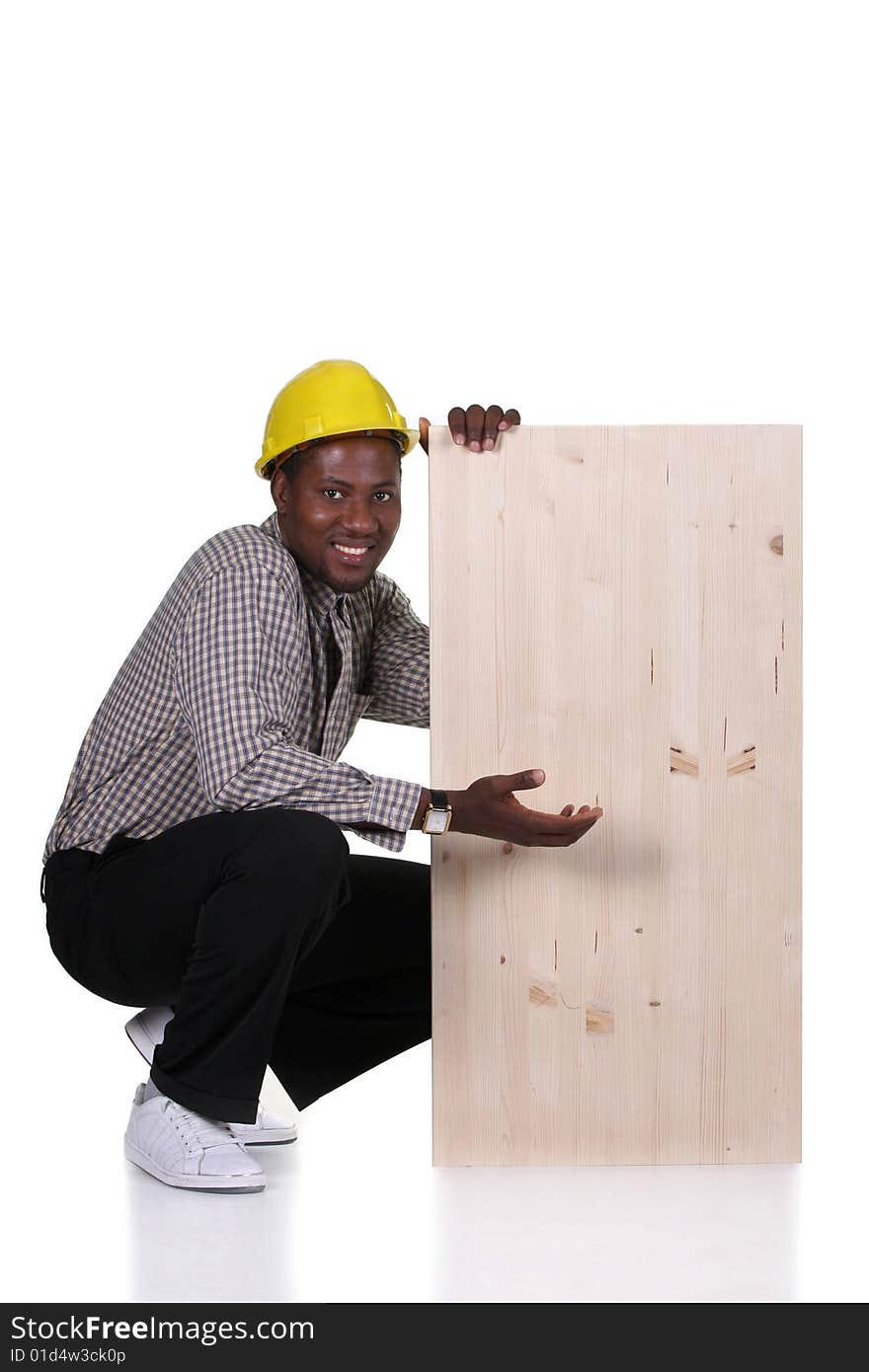 Young african american carpenter holding wooden plank on white background