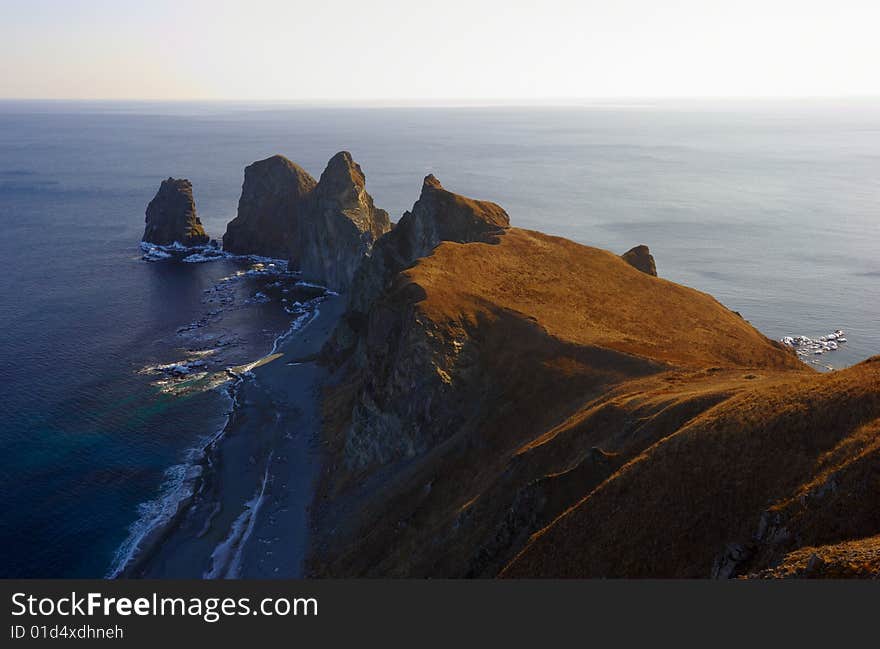 Sunset on cape of Four Rocks. The Far East. Russia. Sunset on cape of Four Rocks. The Far East. Russia.