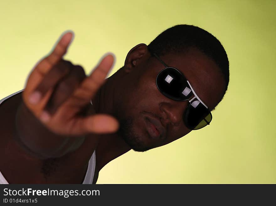 Young african american male on yellow background