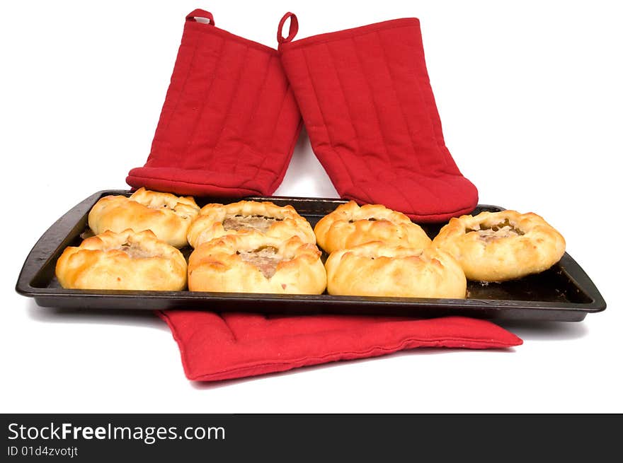 Round fried meat pies on baking tray on white background. Round fried meat pies on baking tray on white background