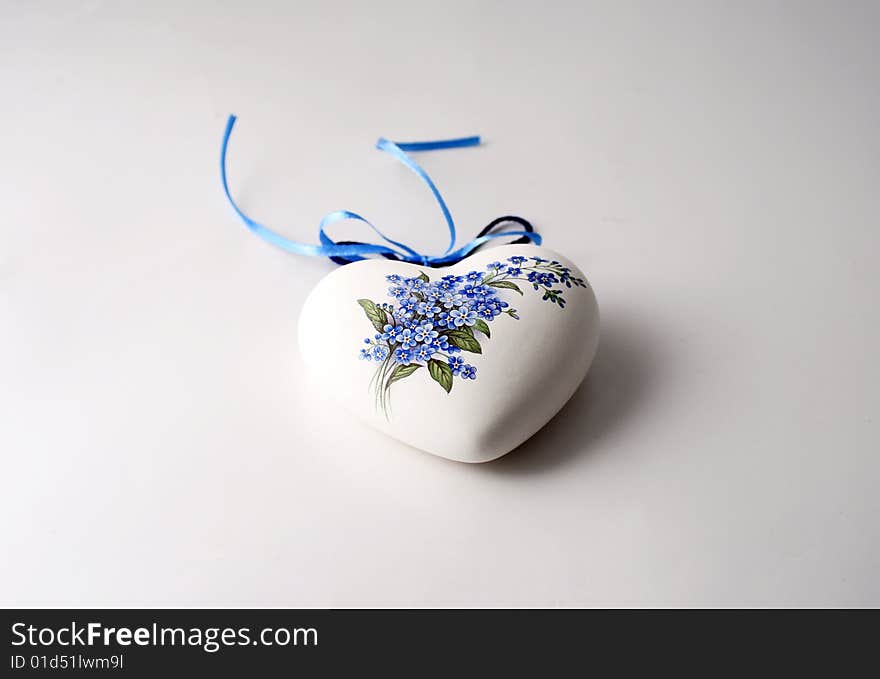 Porcelain heart with floral image glued over