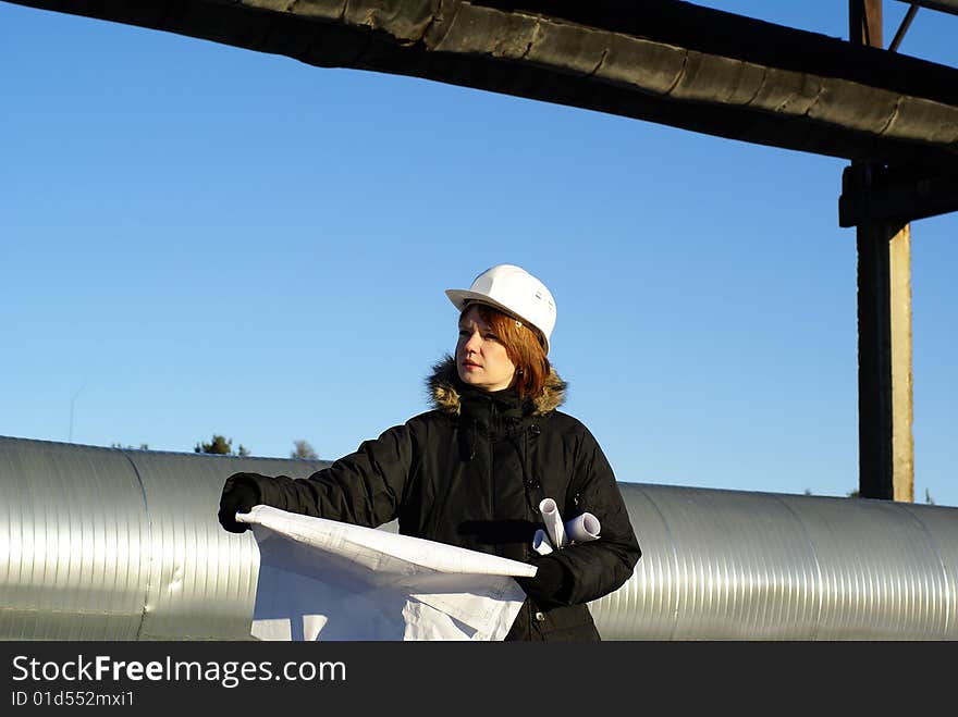 Young architect looking at blueprint