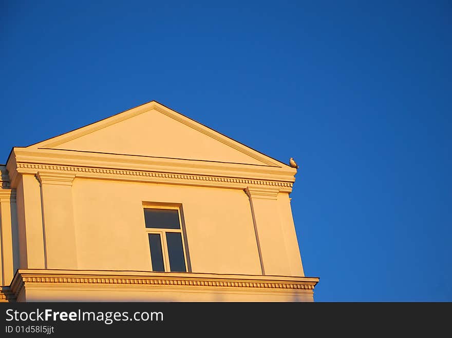 Part of a building standing against blue sky