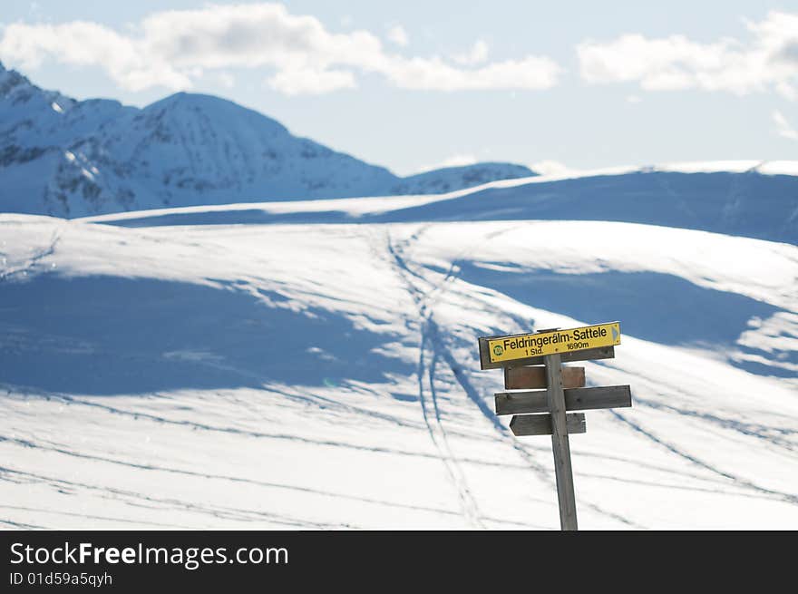 The signpost in the snowy mountains scenery. The signpost in the snowy mountains scenery