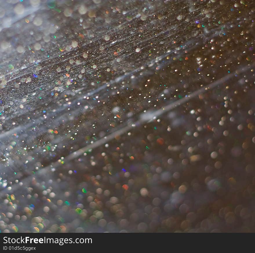 Scratched glass with water drops macro