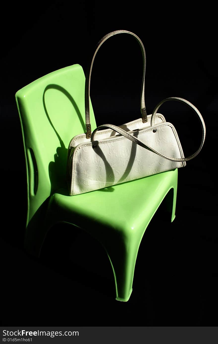 Women Handbag On Green Chair