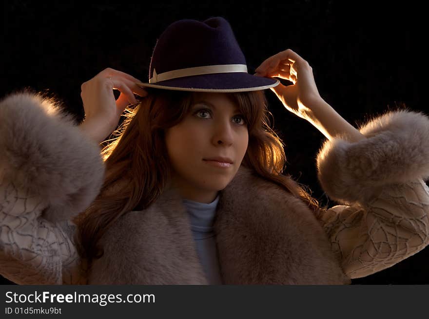 Young lady tryimg on a hat