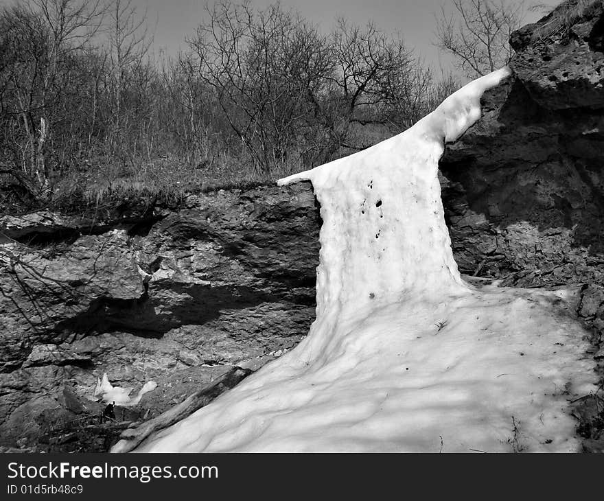 The frozen brook was formed by an icy waterfall