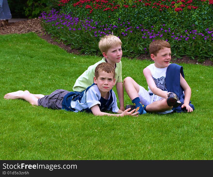 A photograph of three boys playing in summer