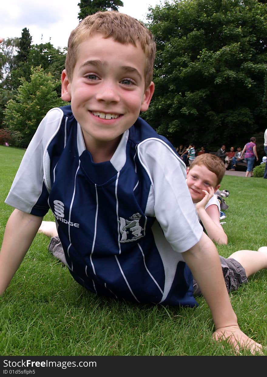 A photograph of a boy playing in summer. A photograph of a boy playing in summer