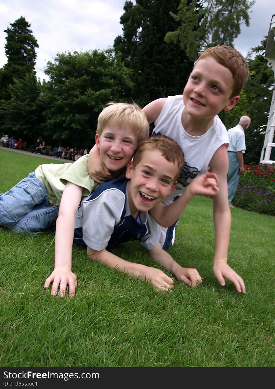 A photograph of three boys playing in summer