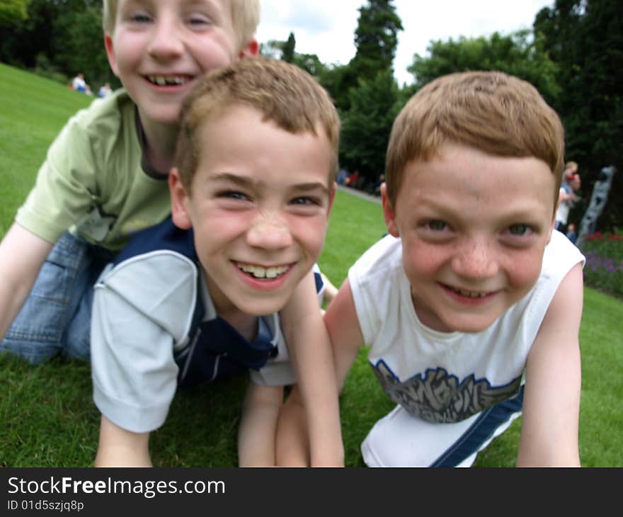 A photograph of three boys playing in summer