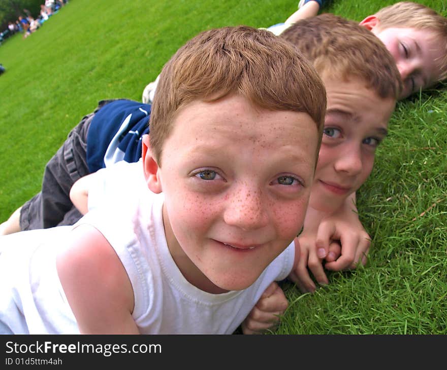 A photograph of three boys playing in summer