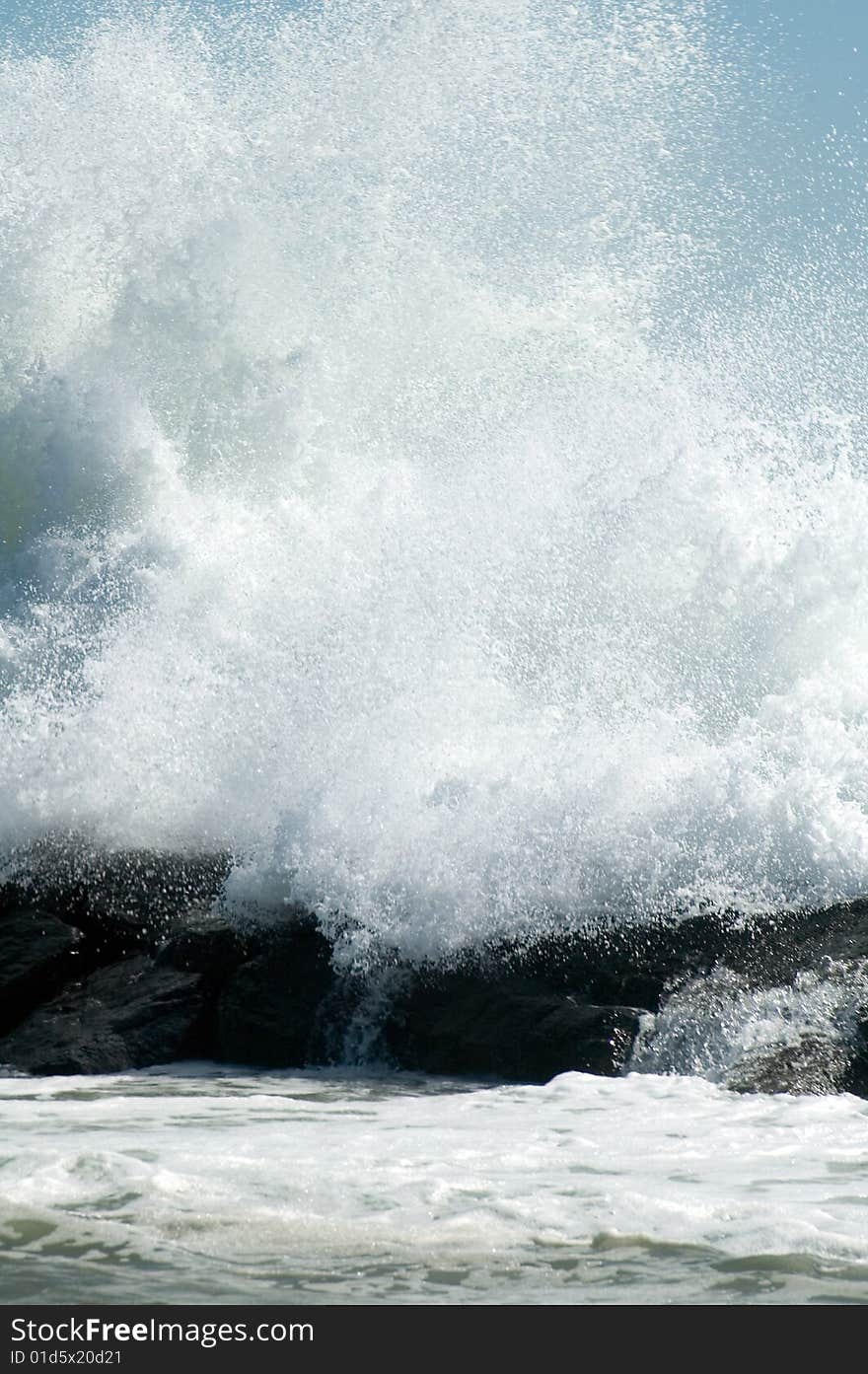 Huge white wave crushing on coastline rocks. Huge white wave crushing on coastline rocks