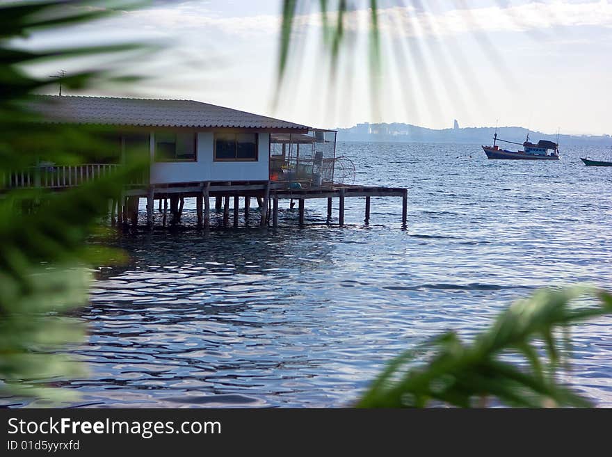 Fishing village house standing on piles in the sea