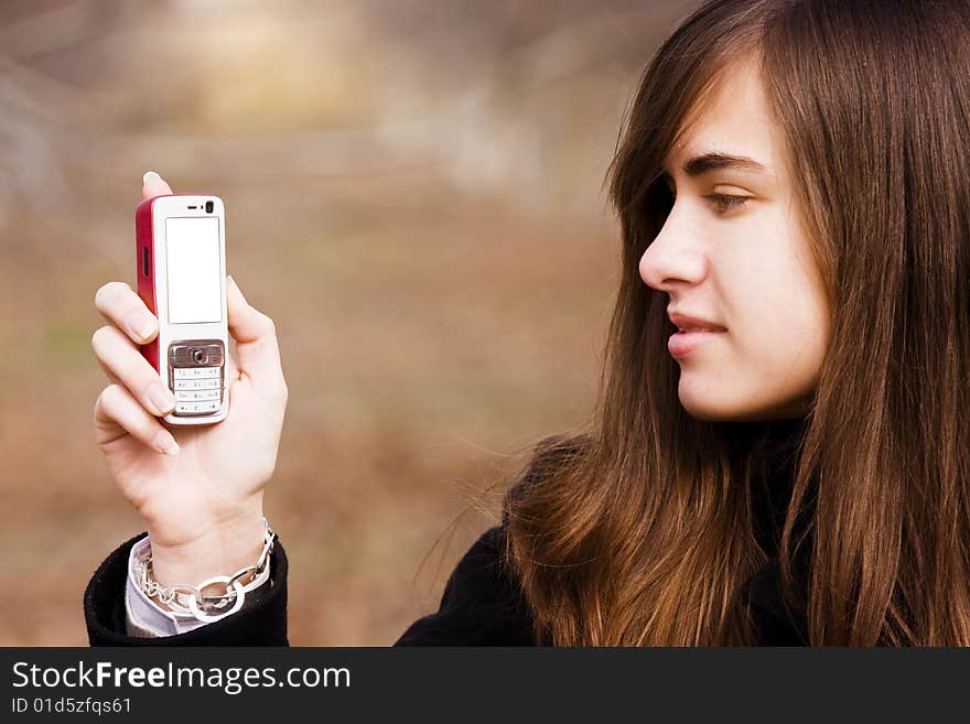 Young beauty showing cell phone with blank screen. Young beauty showing cell phone with blank screen.