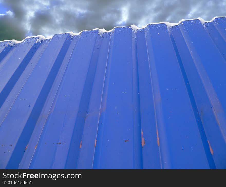 The fence of the construction plant in winter.